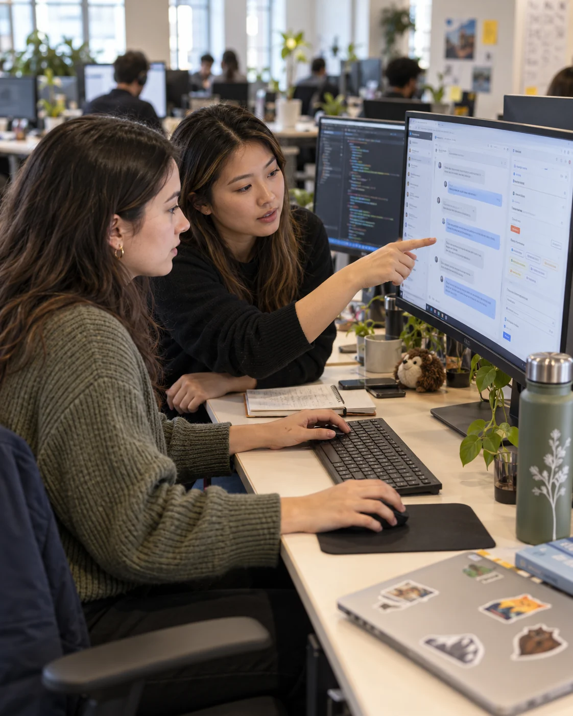 Two NLU analysts review a flagged conversation on a screen together