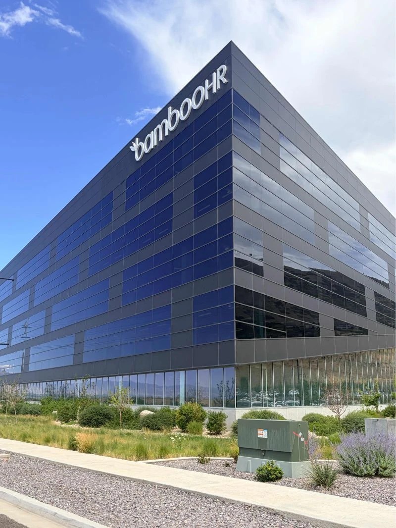 The BambooHR headquarters building in Utah: a large dark glass building with the BambooHR sign at the top corner
